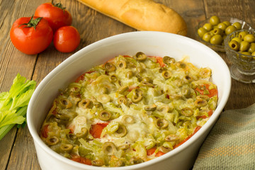 vegetable casserole with tomatoes and olives on a bread basis