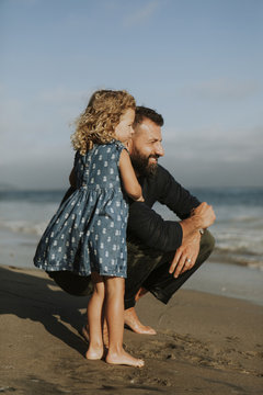 Cheerful father and daughter on the beach