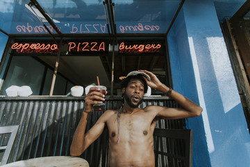 Shirtless man sitting at a cafe