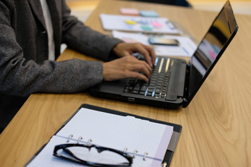 Fototapeta na wymiar hand typing on computer laptop keyboard working at office