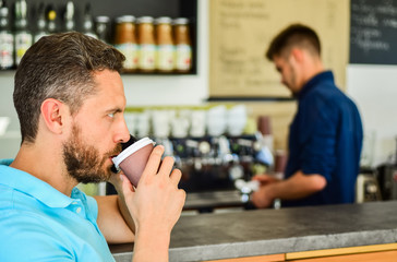 Man speak mobile phone and drink coffee cafe bar background. Traditional beginning of his day. Man solving problems phone drink coffee. Confident entrepreneur communicate mobile. Start great day