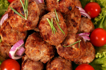 meatballs with tomatoes and salad close up
