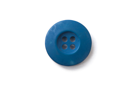 closeup of blue sewing button on white background
