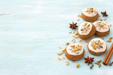 Fragrant Honey Christmas gingerbread with glaze, nuts and seeds on a light blue background with...