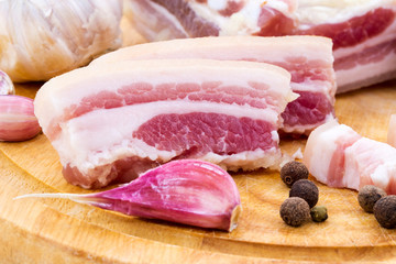 National Russian and Ukrainian food is salo. Sliced bacon on a wooden board. On a white background.