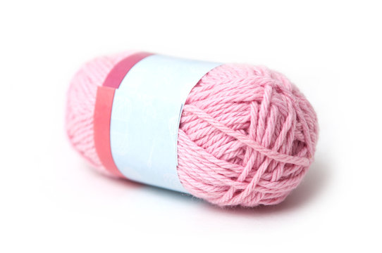 closeup of pink wool bobin on white background