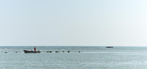 Naklejka premium fisherman on the boat in the mediterranean sea