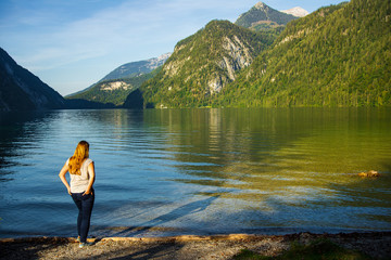 Woman enjoying the late summer view at a lake late in the afternoon