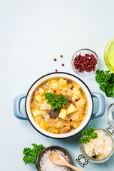 Traditional sauerkraut soup, shchi with meat and vegetables. Top view, space for text.