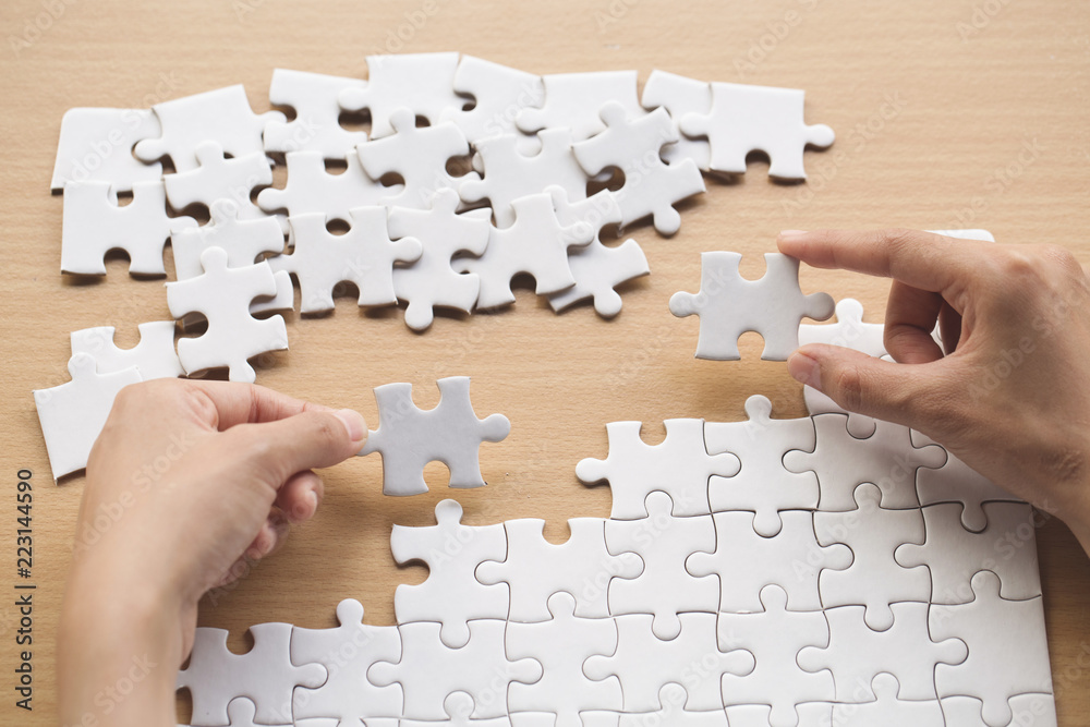 Wall mural close up of hands business women connecting jigsaw puzzleon, teamwork workplace success and strategy