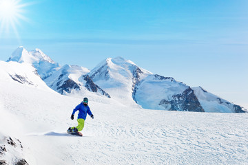 Winter snowboarding activity on sunny day in Alps