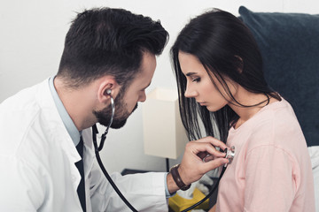close-up shot of doctor listening breath of female patient