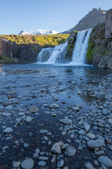 waterfall in iceland in the mountain