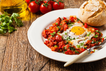 Shakshouka, dish of eggs poached in a sauce of tomatoes, chili peppers, onions