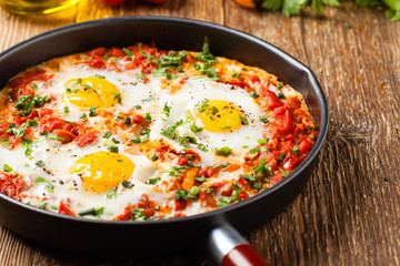 Shakshouka, dish of eggs poached in a sauce of tomatoes, chili peppers, onions