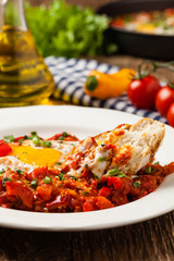 Shakshouka, dish of eggs poached in a sauce of tomatoes, chili peppers, onions