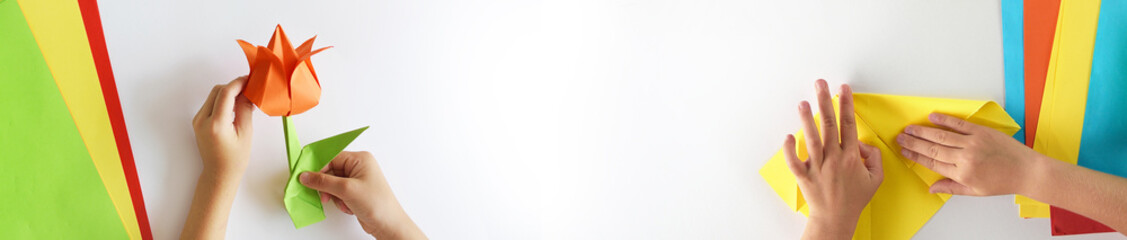 Web banner, origami kids.  Color cranes of origami from paper on a white background