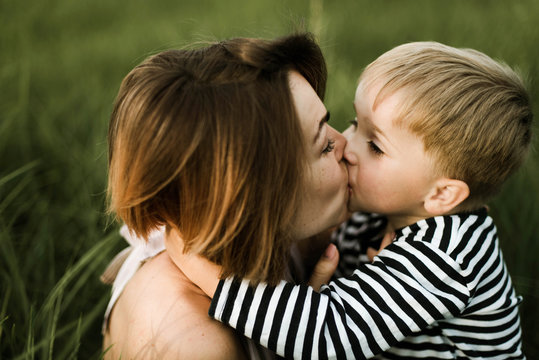 little boy kisses his mom