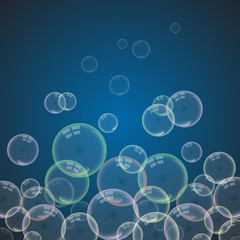 Isolated colorful realistic shampoo bubbles with a reflection of a transparent dark background.