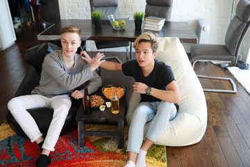 Football fans watch the match and drink beer