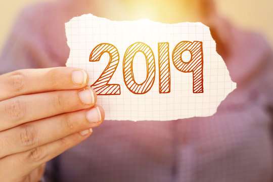 business woman holding tear paper with 2019, new year concept
