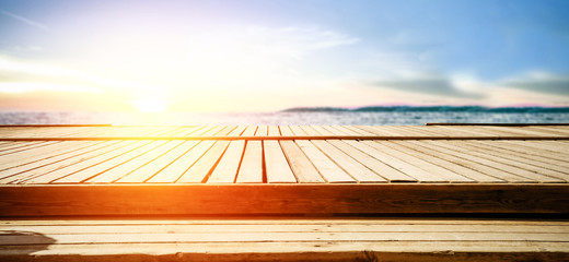 Summer sunset with landscape of sea and wooden pier with free space for your decoration. 