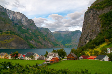 Scenic view of the small village with colorful houses at the bank of the Aurland fjord in Undredal,...