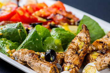 salad with chunks of meat and dressing