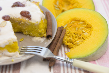 Pumpkin homemade cheesecake with white cream. Autumn still life. Thanksgiving day food.