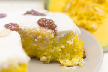 Piece of pumpkin homemade cheesecake with white cream. Thanksgiving day food.