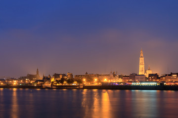 Fototapeta na wymiar Beautiful cityscape of the skyline of Antwerp, Belgium, during the blue hour seen from the shore of the river Scheldt 