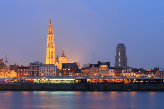 Beautiful cityscape of the skyline of Antwerp, Belgium, during the blue hour seen from the shore of the river Scheldt
