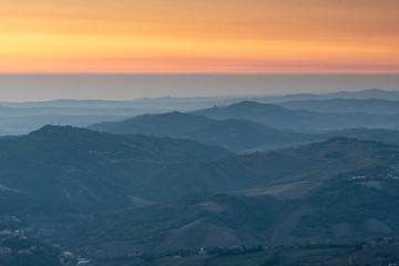 Layered mountain ranges at sunrise