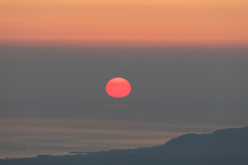 Sun rising over misty sea I