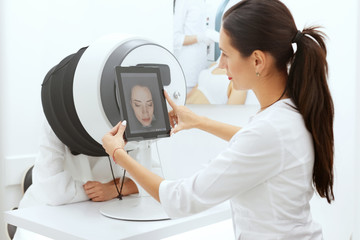 Face Skin Analysis. Woman At Cosmetology Doing Skin Diagnostic