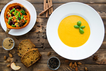 Autumn pumpkin spice. Pumpkin soup with basil leaves, baked pumpkin with vegetables, carrot, beans, haricot and corns. Pumpkin spice cake slices. Top view.