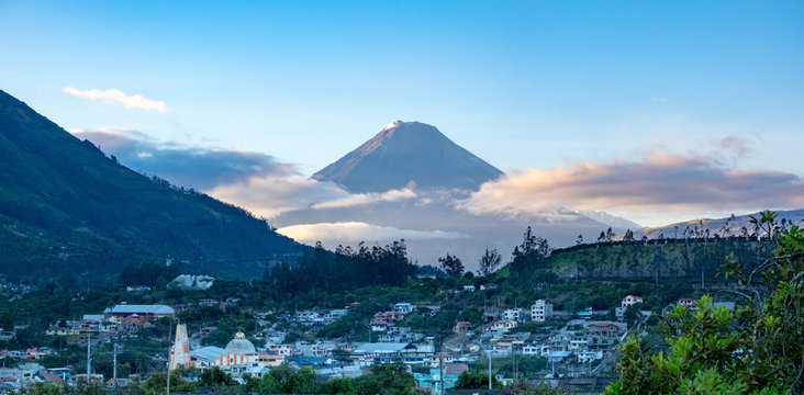 Town and volcano during sunrise in Andes of Ecuacor