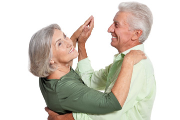happy senior couple dancing on white background