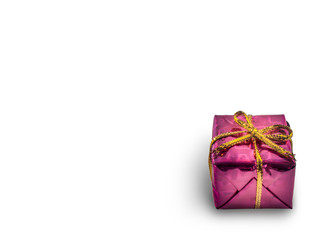 Pink gift box with a golden color bow isolated on white background