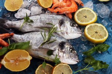 Delicious fresh fish. Fish with aromatic herbs, spices and vegetables - healthy food, diet or cooking concept.