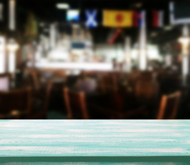 Wood table with blured background cafe , for your photo montage or product display. Space for placing items on the table.