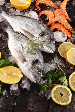 Delicious fresh fish. Fish with aromatic herbs, spices and vegetables - healthy food, diet or cooking concept.