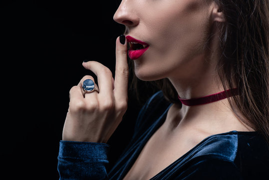 cropped view of vampire showing silence symbol isolated on black