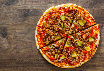 Pizza with Mozzarella cheese, minced meat and vegetables. Italian pizza on wooden background. with copy space. top view