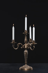 candelabrum with flaming candles on black background - obrazy, fototapety, plakaty