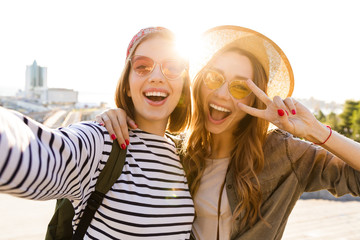 Two excited young girls friends having fun together