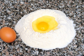 homemade cake, flour and eggs on marble background