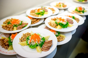 Many sets of food on white dish stand by to serve in wedding ceremony. 