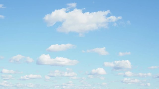 Many Little Fluffy Clouds Float In Blue Sky