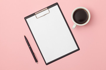 Minimal modern office desk workplace with blank notepad, pen, coffee cup and supplies. Copy space on color background. Top view. Flat lay style. Mockup